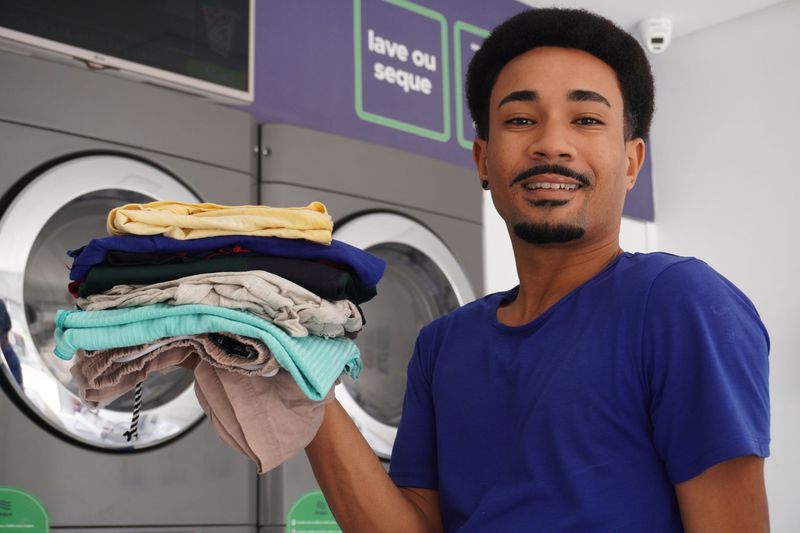 Freshly folded clothing beside a travel suitcase after a one-time laundry service order